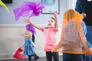 children playing with scarves