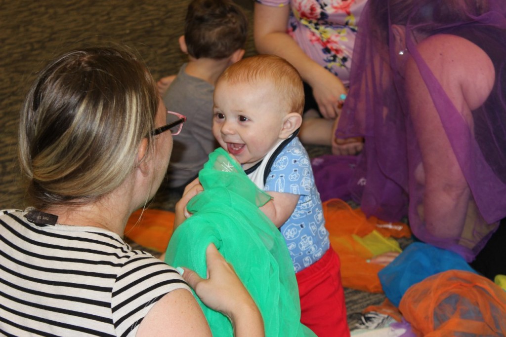 baby playing with scarves