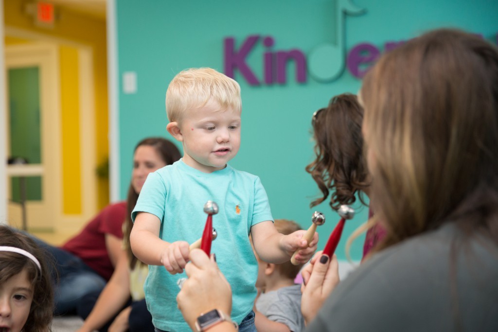 child playing with bells