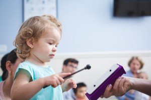 child playing resonator bar