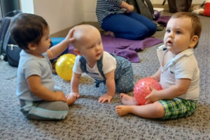 Babies playing with nubby balls
