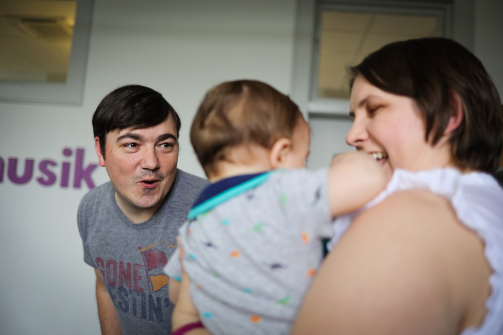 mom and dad present with their baby at Kindermusik