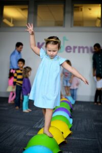 toddler girl walking and balancing on bilibo